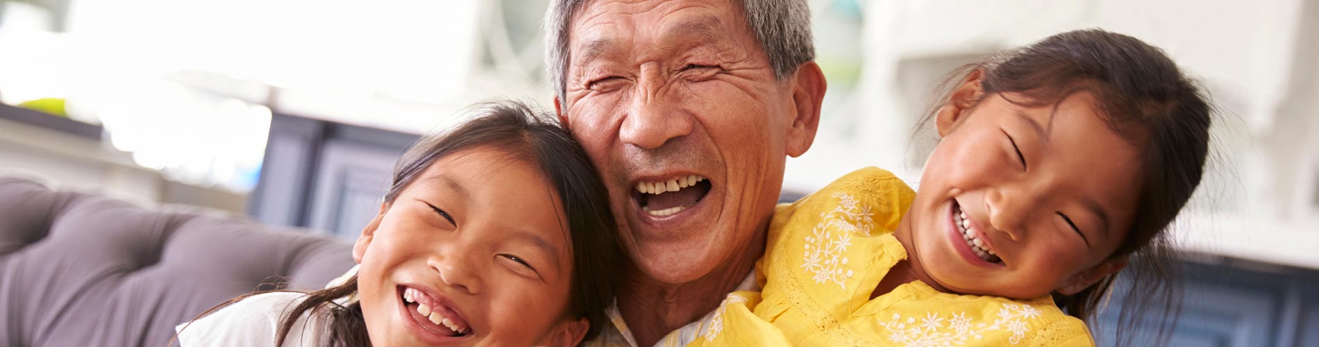 Older Asian man with two children