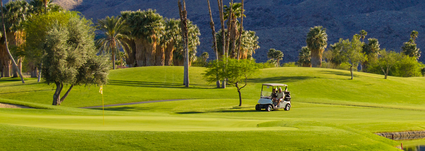 People in golf cart on golf course