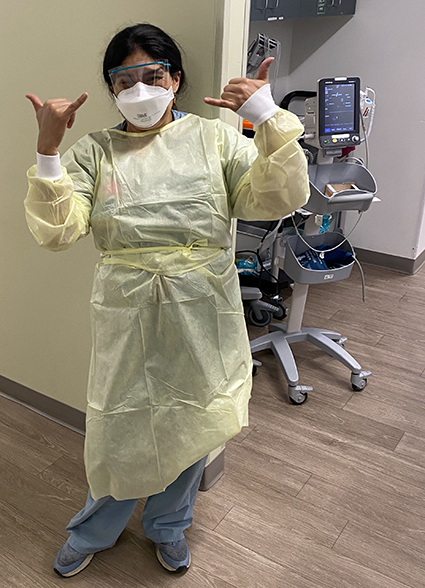 Iris Ruvalcaba in cap, mask and smock