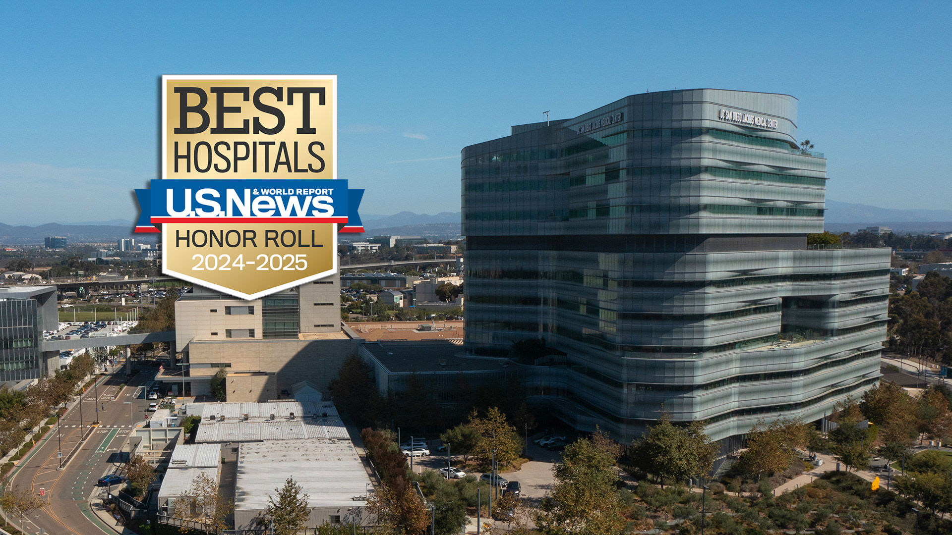 U.S. News & World Report's Honor Roll badge against the backdrop of the Jacobs Medical Center building seen from the top